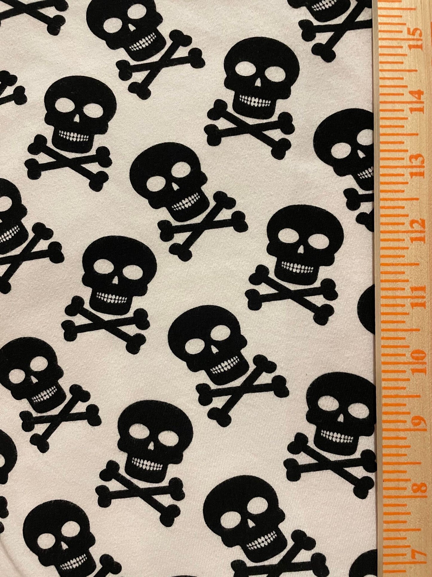 Black Skulls on White Cotton Lycra Fabric