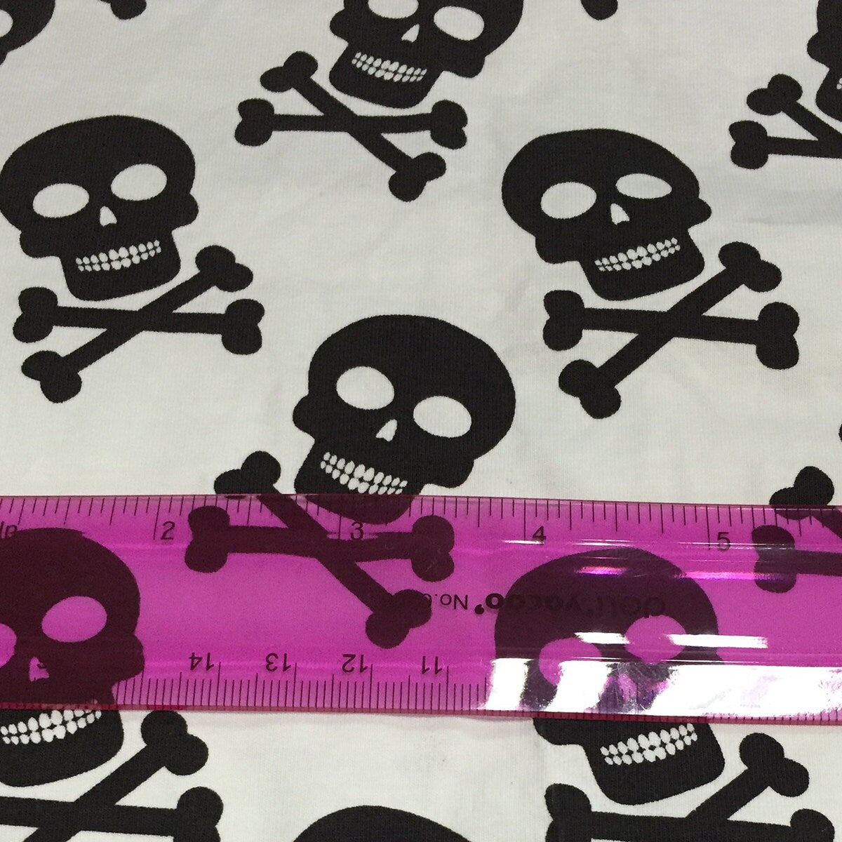 Black Skulls on White Cotton Lycra Fabric